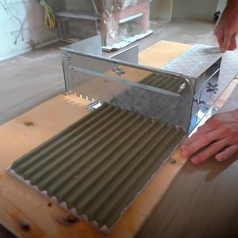 Two-side adjustable notched tile trowel (from 33cm to 60 cm).